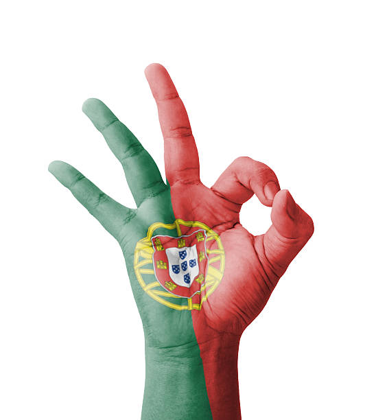 Hand making Ok sign, Portugal flag painted as symbol of best quality, positivity and success - isolated on white background