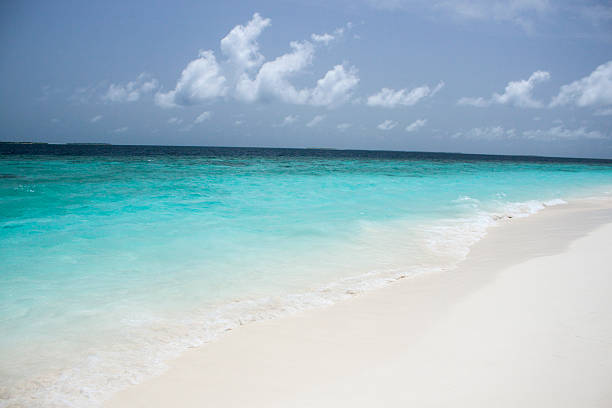 istock Crystal transparent sea and blue sky with white clouds 187302083