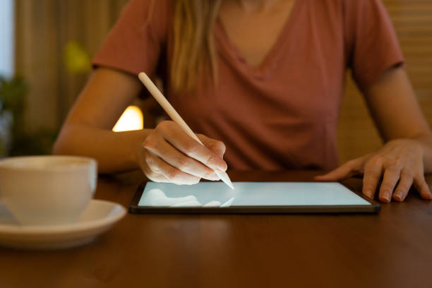 istock Young woman looking at a modern digital tablet computer screen 1873024654