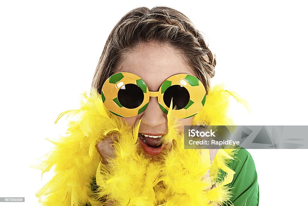 Excited female sports fan cheers on her soccer team A woman dressed in green and yellow colored fancy dress supports the Brazilian soccer team for the 2014 World Cup 2014 Stock Photo