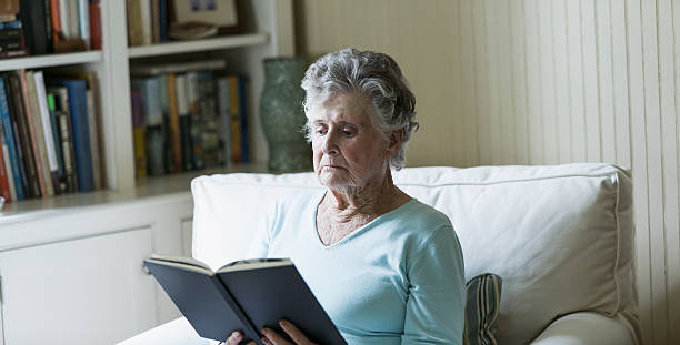 istock Elderly woman reading book 187306010