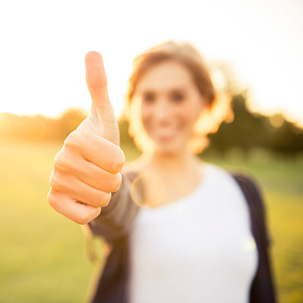 istock Young woman with thumbs up 187307352