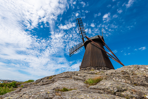 Wide angle photo of an old traditional wooden flour windmill.