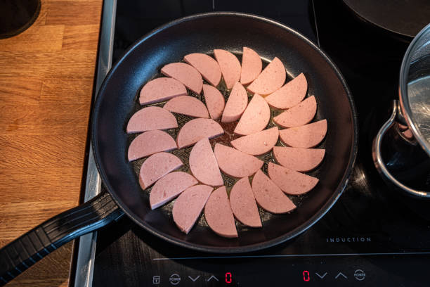 istock Fresh falukorv in a frying pan.. 1873083293