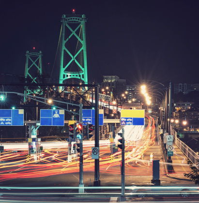 A blur of late night traffic on a toll bridge.