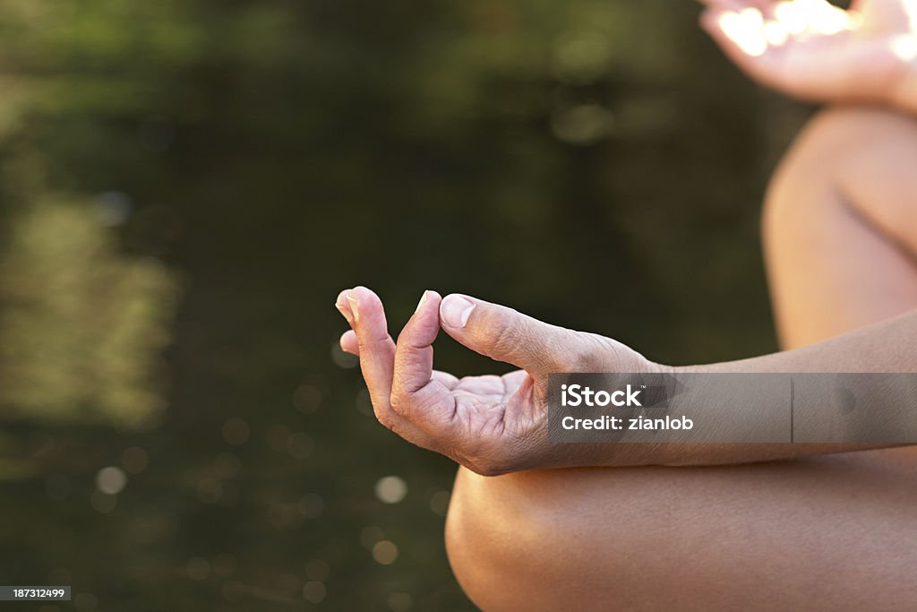 Yoga in the river. Adult woman doing yoga in a river. Adult Stock Photo