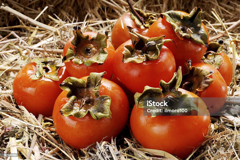 Japanese persimmon Japanese persimmon fruits in a wicker basket Autumn Stock Photo