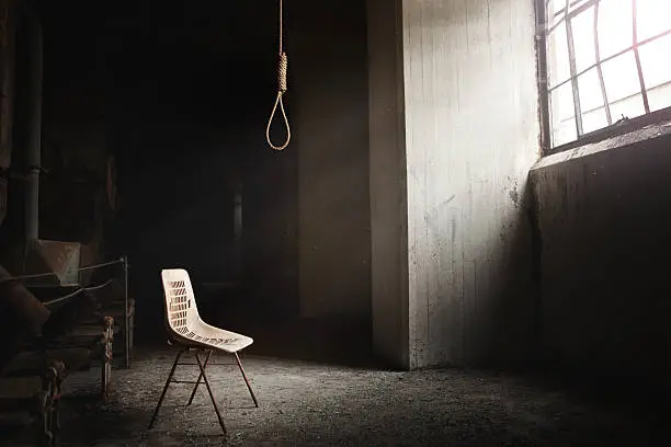 Hangman Noose with thirteen loops setup in an abandoned building. Beautiful rays of light coming from the window.