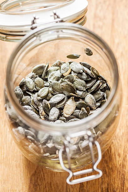 istock Dry pumpkin seeds in a glass jar 187314979