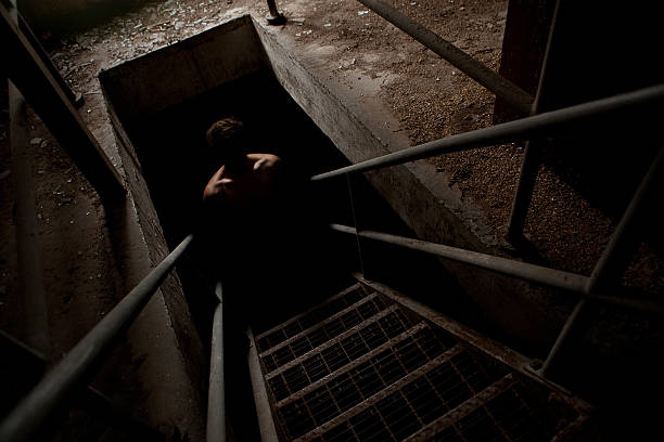 istock Scary man silhouette in the dark staircase 187315383
