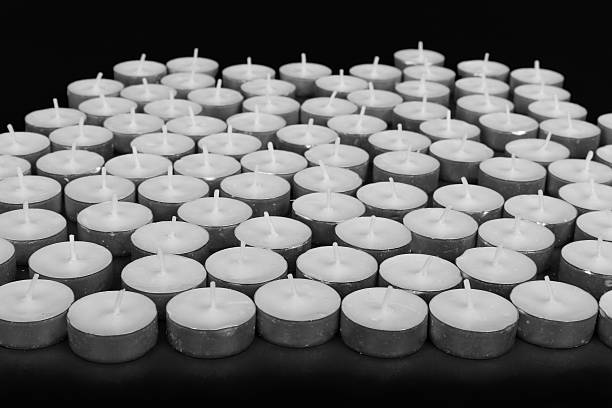 istock Group of white candles at a black background 187315736