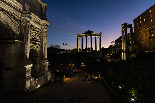 Views and sightseeings of Rome: the Roman Forum during a colorful winter sunset. Arch of Septimius Severus