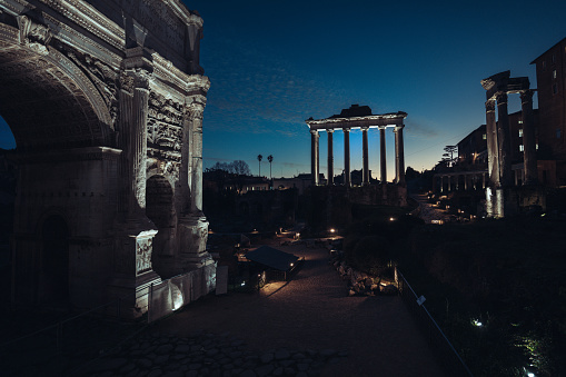 Views and sightseeings of Rome: the Roman Forum during a colorful winter sunset. Arch of Septimius Severus