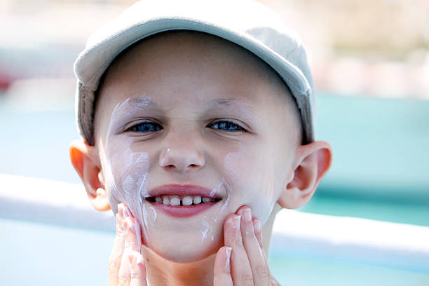 chemo child with sun cream stock photo