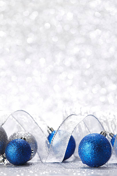 istock Blue Christmas balls and ribbon on silver sparkle background 187316519