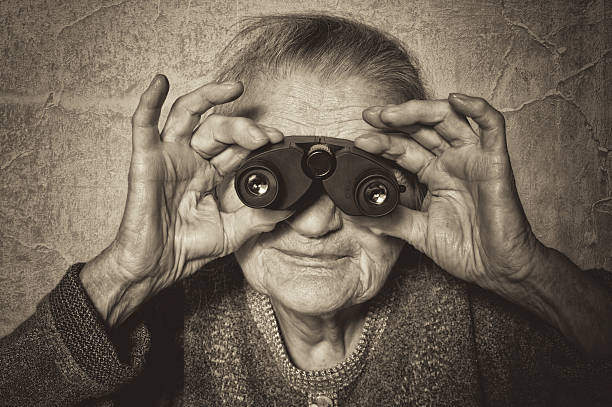 istock Elderly woman looks through binoculars. 187316554