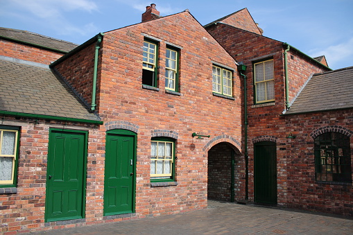 Newly build vintage houses with old style sliding sash windows, green doors
