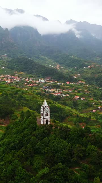 AERIAL View of Our Lady Of Fatima Chapel on Green Hill surrounding Mountains, Sao Vicente, Madeira Island