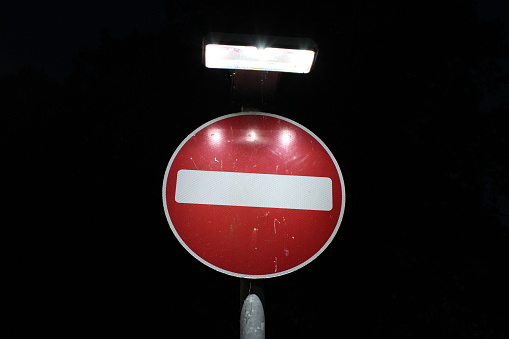 British no entry road sign, red no entry sign taken at night, sign illuminated