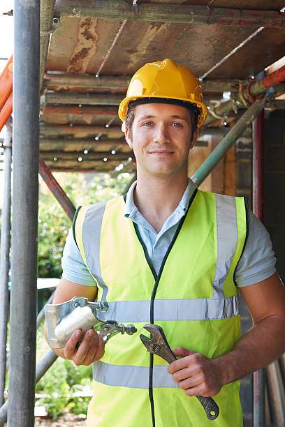 istock Portrait Of Builder Putting Up Scaffolding 187318419