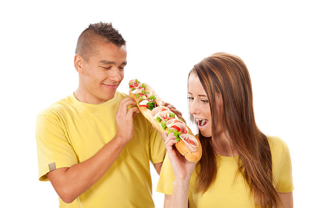 istock Young  woman and man bear a great sandwich. 187318507
