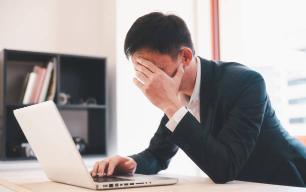 istock man having stressful time working on laptop headache and multitask with business man in office for deadline, burnout and overworked 1873195619