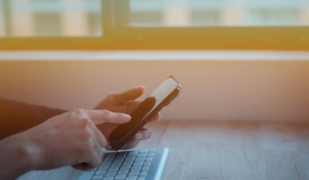 istock Social media marketing concept. businessman hand using smartphone typing, chatting conversation in chat box icons pop up in modern office 1873196642