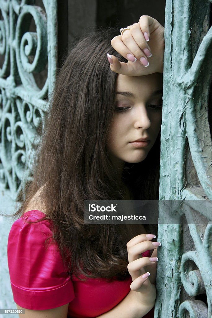 Young caucasian woman near the gates Adult Stock Photo