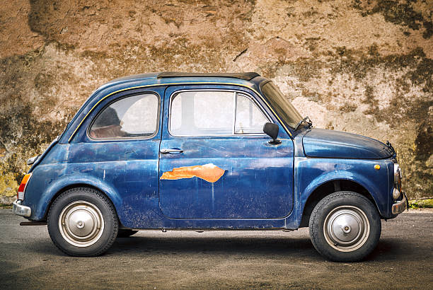 Yellow vintage small italian car isolated on white