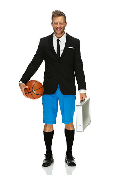 istock Young man standing with basketball and suitcase 187323697