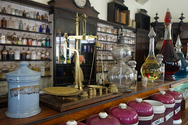 Counter of old chemist with scales and glass bottles stock photo