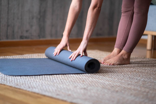 istock a woman setting up a treadmill to train 1873239384