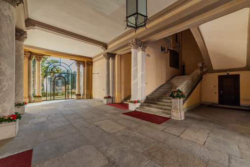 Cuneo, Piedmont, Italy - December 19, 2023: The atrium with the grand staircase of Cuneo Prefecture building (1882) on Via Roma, a majestic neoclassical building