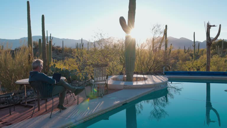 Mature man enjoys sunrise moments by desert pool