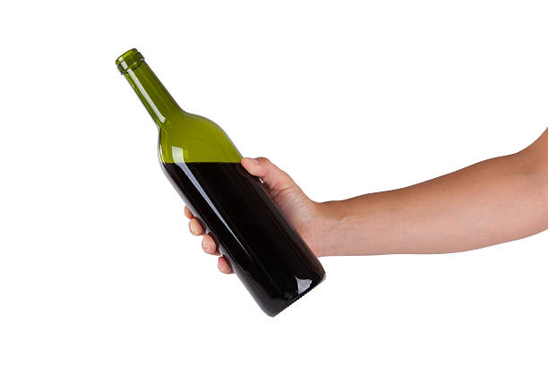 Hand holding a bottle of red wine stock photo