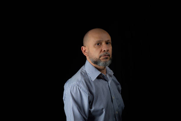 istock Serious, bald and bearded man looking at the camera 1873260011