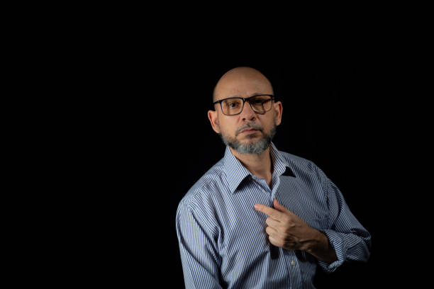 istock Serious, bald and bearded man looking at the camera 1873260516