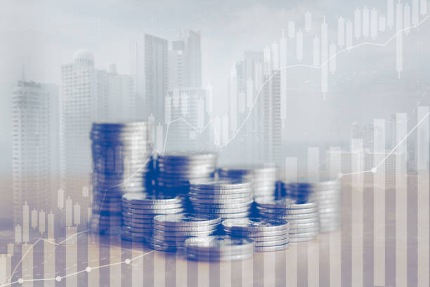 istock Double exposure of silver coin stack with trading graph chart and cityscape background. Economic, business, financial, interest rate, dividend, Investment for real estate, stock market growth concept. 1873271133