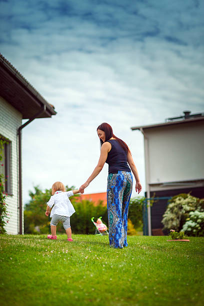 istock Mother and daughter outside their house 187327982