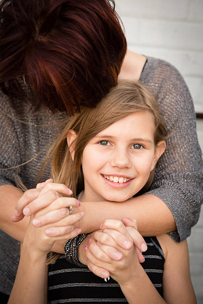 istock Mother Embracing Her Daughter, in Outdoor Setting 187327995