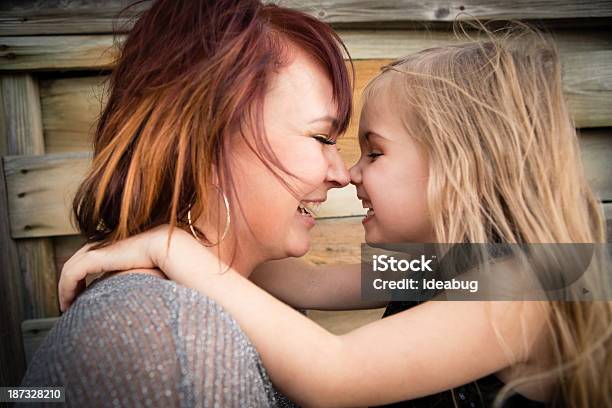 Mother And Little Daughter Cuddling In Outdoor Setting Stock Photo - Download Image Now
