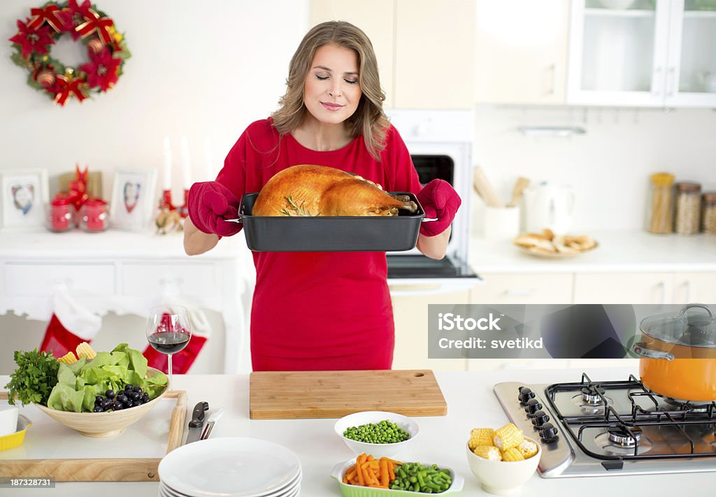 Woman holding roasted turkey for christmas dinner. Christmas Stock Photo