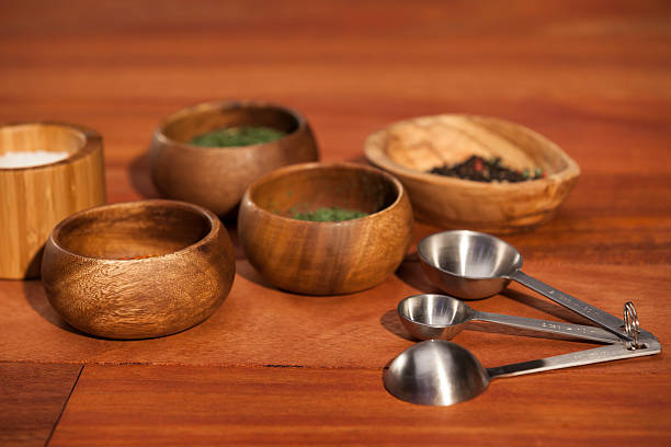 istock Measuring spoons with wood spice bowls on counter top 187329839