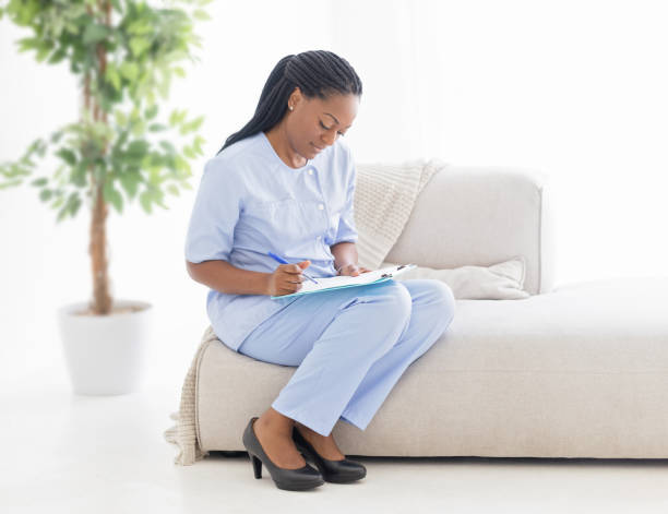 istock Nurse Filling Out a Form 1873298893