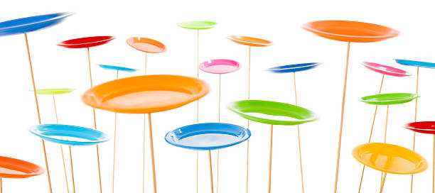 Colourful spinning plates on white background stock photo