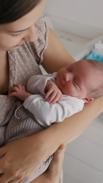 SLO MO Loving Mother Carrying Adorable Newborn Baby in her Arms at Home