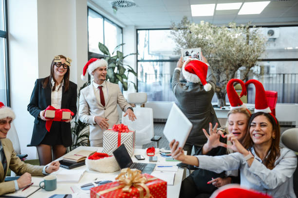 istock Fun Christmas Selfies By Smiling Colleagues In Office 1873301986