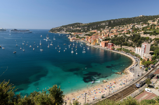 Panoramic image of Port Fontvieille - Monaco, top view from Monaco Ville, azur water, sun reflections on the water, harbour at sunny day, luxury apartments, a lot of yachts and boats, mountain. High quality photo