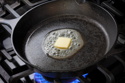 Skillet with butter melting in it.