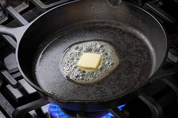 Melting Butter Skillet with butter melting in it. skillet cooking pan photos stock pictures, royalty-free photos & images